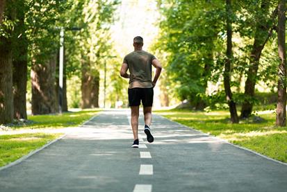 back-view-of-jogger-running-at-green-park-on-summe-RESWZDK.jpg